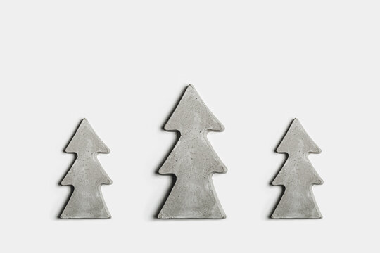 Hand made concrete christmas trees on white background