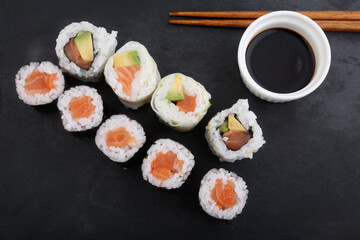 sushi makis with sticks and soy sauce