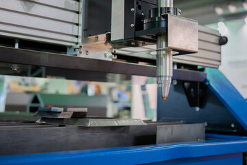Automatic cnc plasma cutting machine working with sheet metal at factory, plant. Metalworking, industrial, equipment, technology, machining, manufacturing concept