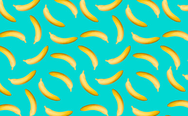 Pattern with whole bananas with a shadow on the turquoise surface as a decorative background.