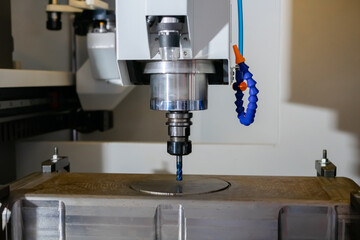 Turning milling machine with cooling system cutting metal workpiece at factory, plant, exhibition. Metalworking, engraving, industrial, equipment, production, technology, manufacturing concept