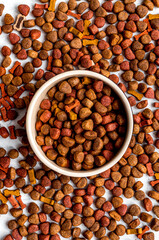 dry dog food in bowl on white background top view