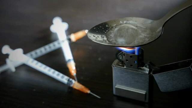 cinemagraph,preparing a narcotic substance in a spoon on a fire