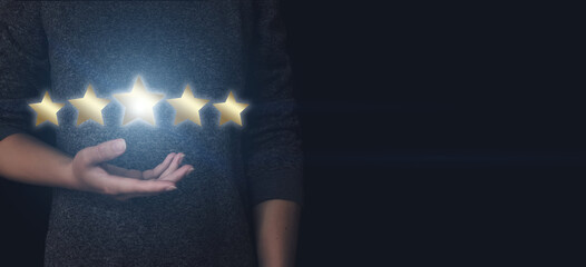 The concept of assessment. Hand pointing to five stars to increase the company's rating, increase...
