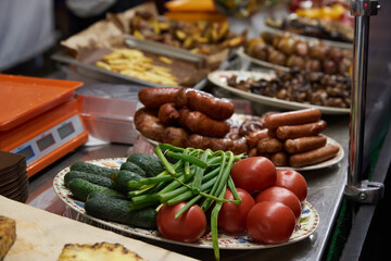 Fried vegetables in dishes on the table, street food