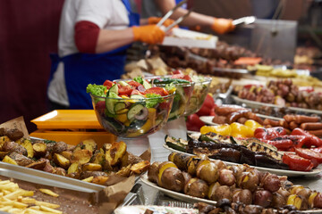 Fried vegetables in dishes on the table, street food