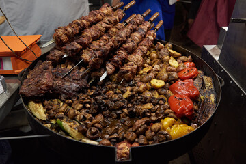 Kebabs, fried meat, potatoes, zucchini, mushrooms, peppers