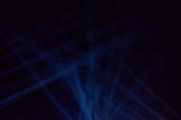 Intersecting beams of a searchlight in the smoke at night