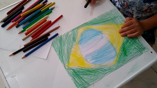 salvador, bahia / brazil - november 18, 2020: child is seen painting a drawing of the flag of Brazil during school activities.