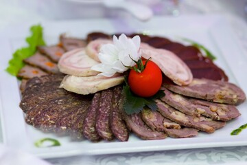 Restaurant dish of sliced meat.