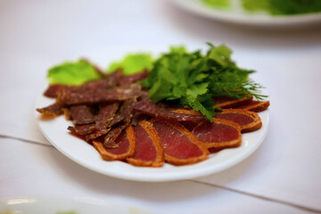 Restaurant dish of sliced meat