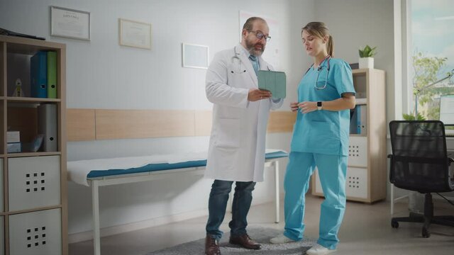 Doctor's Office: Physician Talks With Professional Head Nurse, Using Digital Tablet Computer