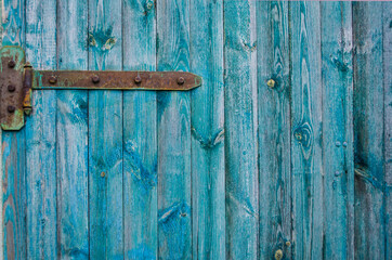 Vintage wooden background with faded turquoise peeling paint.