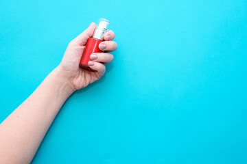 Beautiful woman's hands on the blue background. Well-groomed female hands with a beautiful manicure in nude tones.