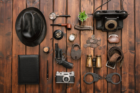 Detective agent equipment on the desk flat lay concept background.