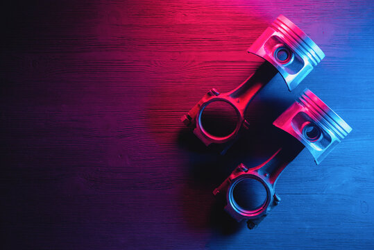 Car engine pistons on the dark background with copy space.
