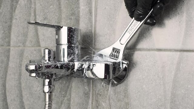 plumber Fixing a leaking tap Faucet by Adjustable wrench , DIY job housework  fix leak repair