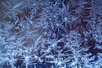 Ice crystals pattern on the window close up. Ice texture. Winter concept