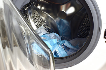 Blue medical masks in the washing machine. washing disposable masks is not safe.