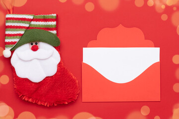 Merry Christmas, decorations on a red background. Holiday envelope with a white letterhead for the inscription. The Christmas gift sock.