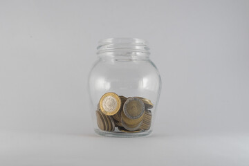 Argentine Coins in money jar on isolated background