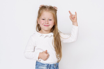 The girl shows a hand gesture. Isolated over white background.