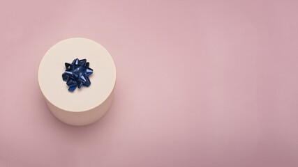 White gift box on pink background 