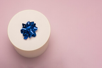 White gift box on pink background 