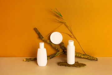 Fototapeta na wymiar Set of natural organic eco cosmetic products in white plastic jar, dispenser bottle, tube on orange background. Skincare concept. Front view, mock up.