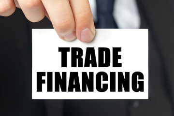 Businessman shows a card with the text TRADE FINANCING