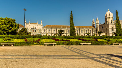 Fototapeta premium The Imperial Gardens and splendour of the Gothic Jeronimos Monastery, Lisbon, Portugal