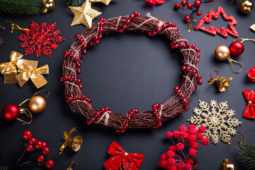 Christmas wreath with decoration. Christmas and New Year black background with ornaments. Space