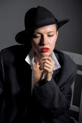 portrait of a beautiful woman in a hat and boyfriend jacket suit