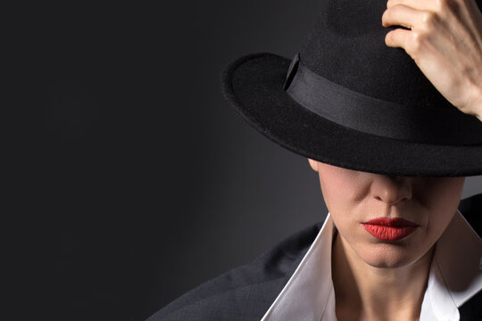 portrait of a beautiful woman in a hat and boyfriend jacket suit