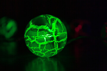 glowing green ball in a dark room