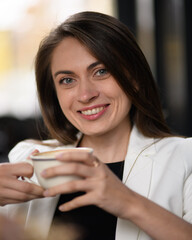 Smiling woman drinking coffee