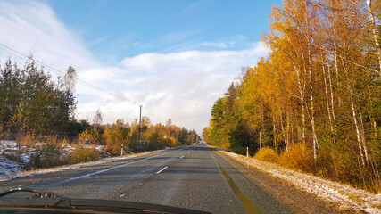 Fototapeta premium View from the car window on the road and nature in sunny day. Transportation and car trip concept.