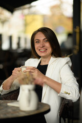 Smiling woman drinking coffee
