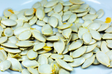 Fresh Pumpkin seeds background. Close up shot.