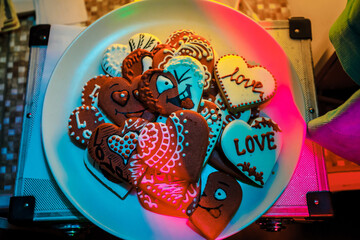 Fototapeta premium Valentines day. Romantic sweet heart cake on the white plate. Red heart shaped cookies on a white plate, symbol of love.