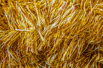 christmas festive background of golden foil tinsel texture close up