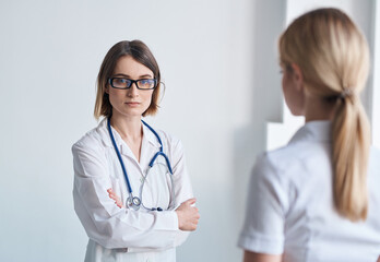 the patient came to the doctor with a stethoscope on a light background