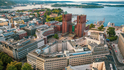 Oslo, Norway. Beautiful panoramic aerial view photo from flying drone to Oslo City Hall (Oslo radhuset)  is a municipal building in Oslo, the capital of Norway. Against the background of port yachts. - obrazy, fototapety, plakaty