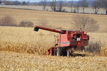 Fototapeta na wymiar Combine harvesting corn in Sothern Wisconsin