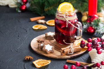 Christmas hot mulled wine with cinnamon cardamom and anise. Dark vintage dirty background. Creative...