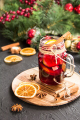 Christmas hot mulled wine with cinnamon cardamom and anise. Dark vintage dirty background. Creative...