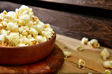 Homemade fresh popcorn in a wooden bowl