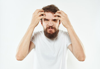 Naklejka premium A man with a thick beard gestures irritably with his hands stress emotions
