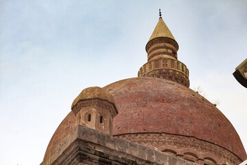 Fototapeta na wymiar Agri, Turkey - May 2018: The minaret of Ishak Pasha Palace near Dogubayazit in Eastern Turkey. Beautiful brown mosque in the middle east. Different view to İshak Pasa Palace