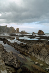 rocky and wild coast with stormy waves hitting the shore